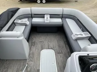 Slide: The Image of 2024 Sweetwater 2286SFL pontoon boat interior with gray seating and cup holders. - 14