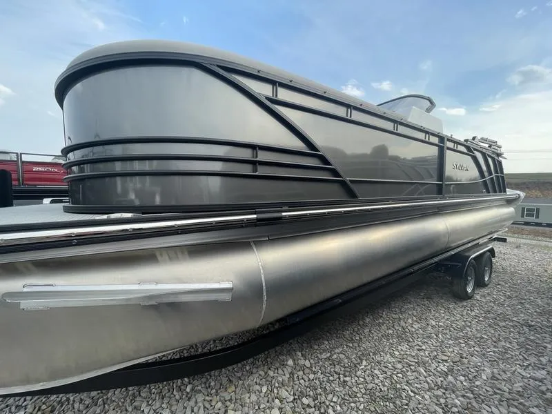 Slide: The Image of 2023 Sylvan S-5 LZ DC pontoon boat on gravel, side view. - 1