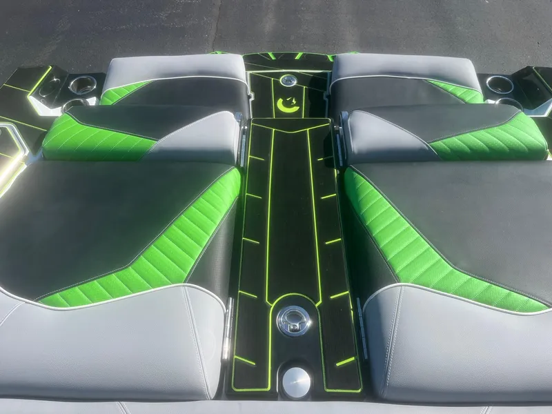 Slide: The Image of 2023 Centurion Fi23 boat interior with green and gray seating, featuring sleek design and modern accents. - 12