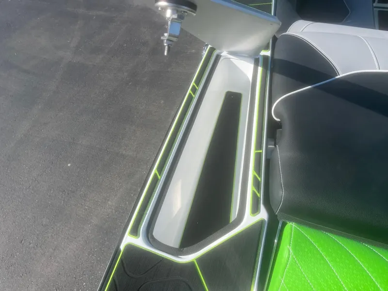 Slide: The Image of 2023 Centurion Fi23 boat interior with sleek design and vibrant green accents. - 14