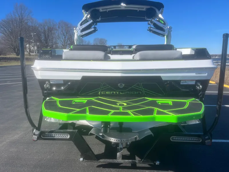 Slide: The Image of 2023 Centurion Fi23 boat rear view with vibrant green accents. - 4