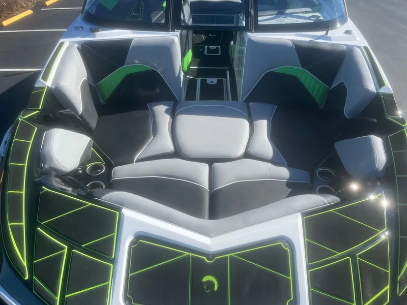 Slide: The Image of 2023 Centurion Fi23 boat interior with modern black and green seating design. - 6