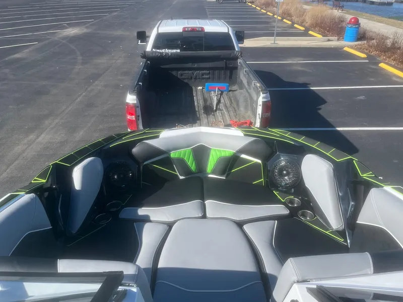 Slide: The Image of 2023 Centurion Fi23 boat interior with truck in parking lot. - 7