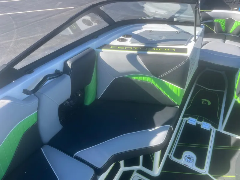 Slide: The Image of 2023 Centurion Fi23 boat interior with green and gray seating and modern design. - 8