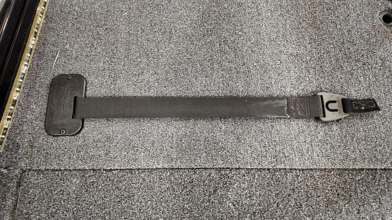 Slide: The Image of 2023 Lowe Stinger 198 boat interior with secure strap on carpeted floor. - 10