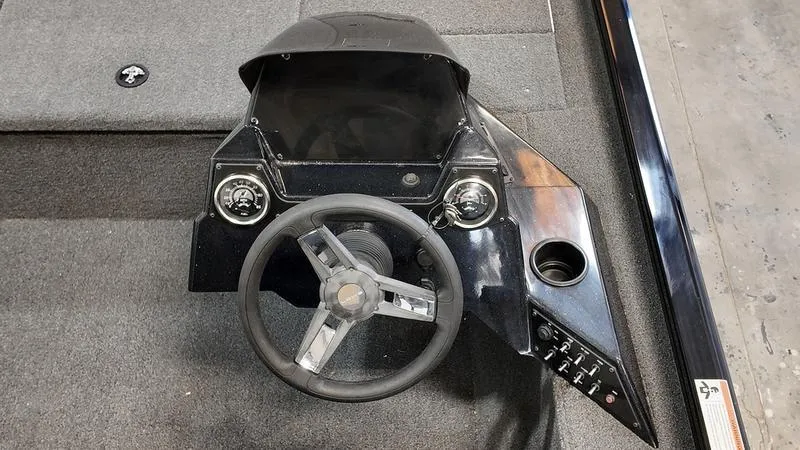 Slide: The Image of 2023 Lowe Stinger 198 boat dashboard with steering wheel and control panel. - 14
