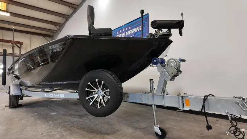 Slide: The Image of 2023 Lowe Stinger 198 boat on trailer in warehouse setting. - 2