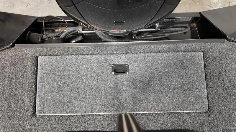 Slide: The Image of 2023 Lowe Stinger 198 boat interior with storage compartment and textured flooring. - 8
