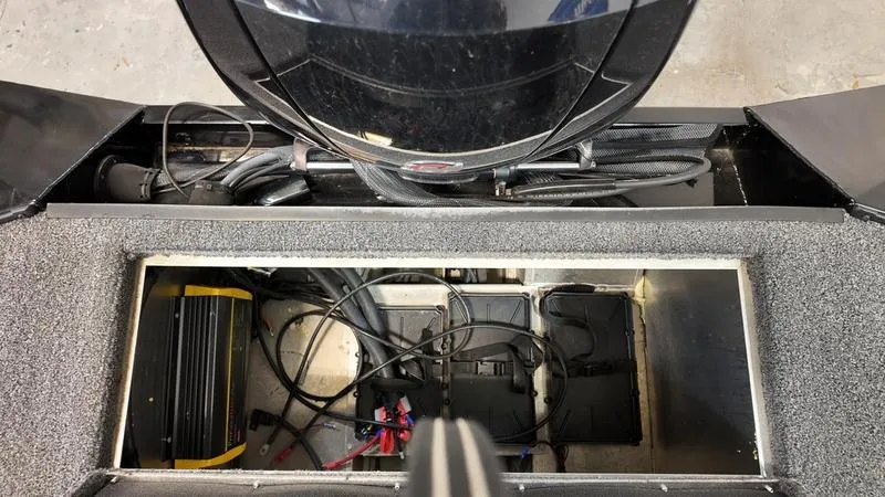 Slide: The Image of 2023 Lowe Stinger 198 boat battery compartment with wiring and equipment. - 9