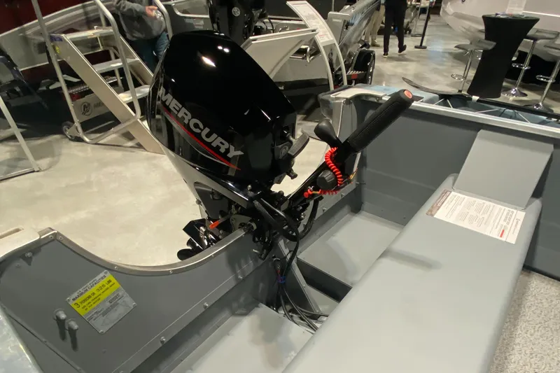 Slide: The Image of 2023 Starcraft Alaskan boat with Mercury outboard motor, showcased at a boat exhibition. - 6