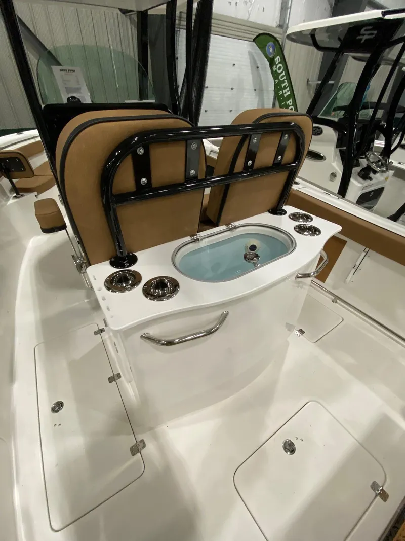 Slide: The Image of 2023 Sea Pro 259 DLX boat interior with seating and livewell. - 11