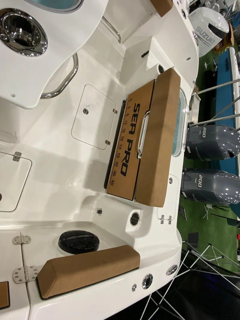 Slide: The Image of 2023 Sea Pro 259 DLX boat interior with seating and storage compartments. - 12