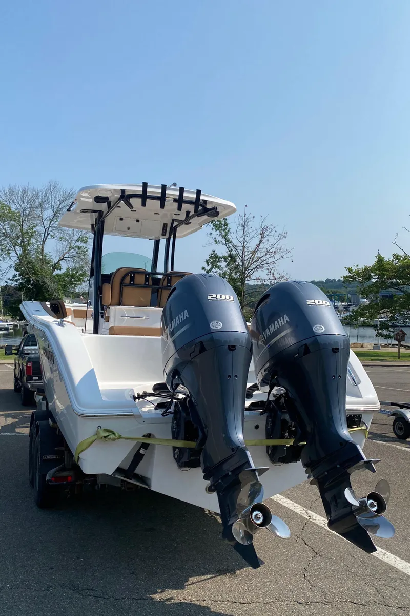 Slide: The Image of 2023 Sea Pro 259 DLX boat with twin Yamaha outboard motors. - 2