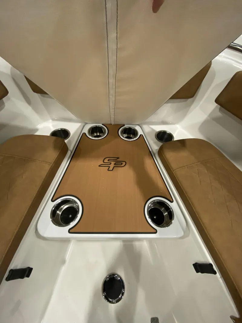 Slide: The Image of 2023 Sea Pro 259 DLX boat interior with cup holders and seating. - 5