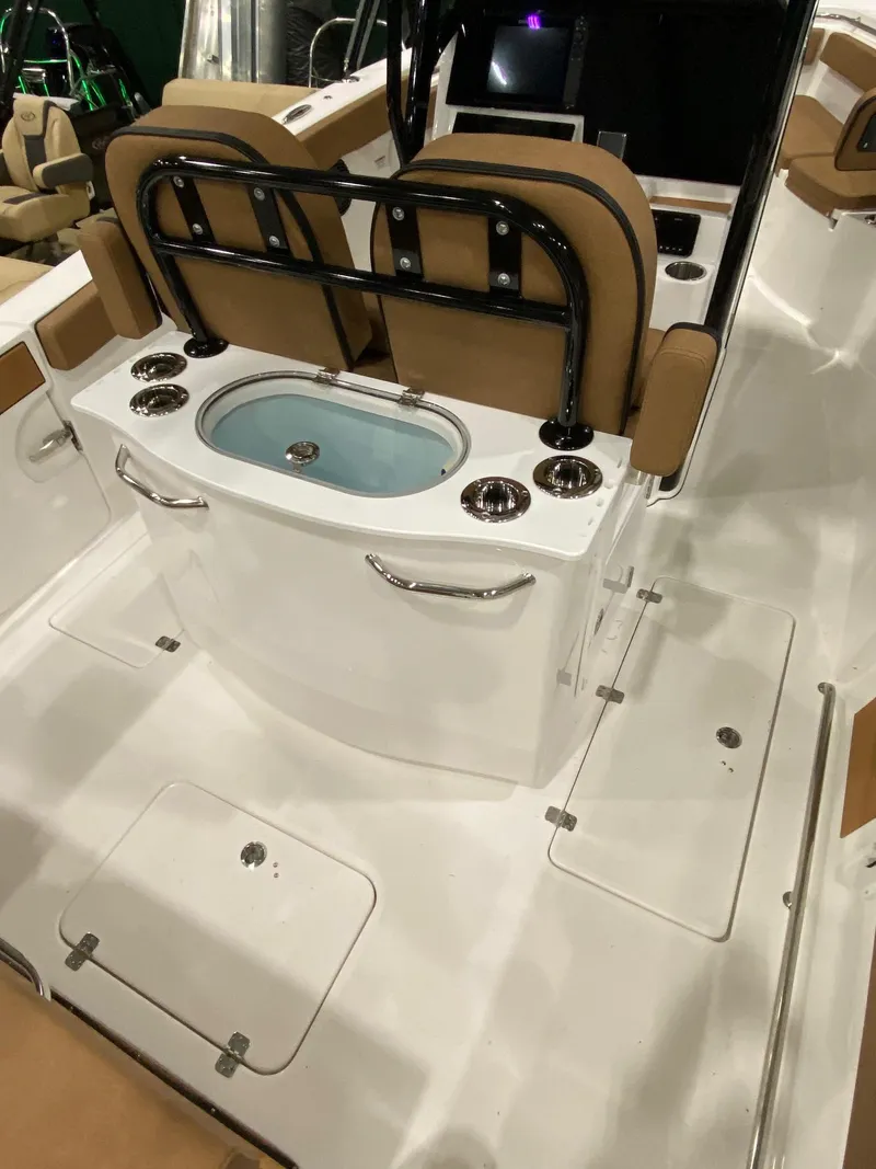 Slide: The Image of 2023 Sea Pro 259 DLX boat interior with seating and storage compartments. - 7