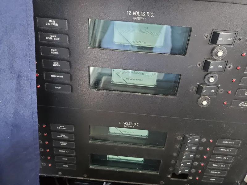 Slide: The Image of Control panel of a 1990 Mainship Mediterranean boat, featuring 12 volts DC battery indicators. - 17