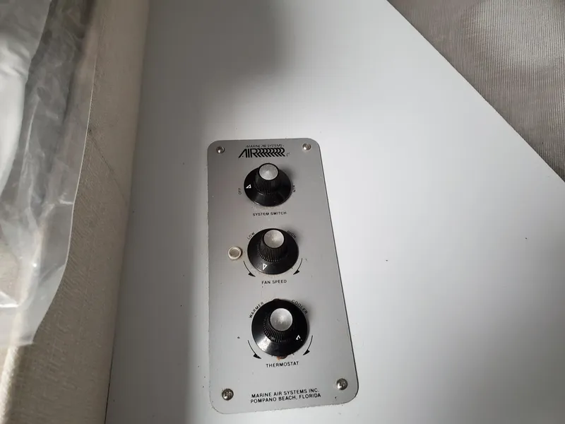 Slide: The Image of Control panel with three knobs on a 1990 Mainship Mediterranean boat. - 20