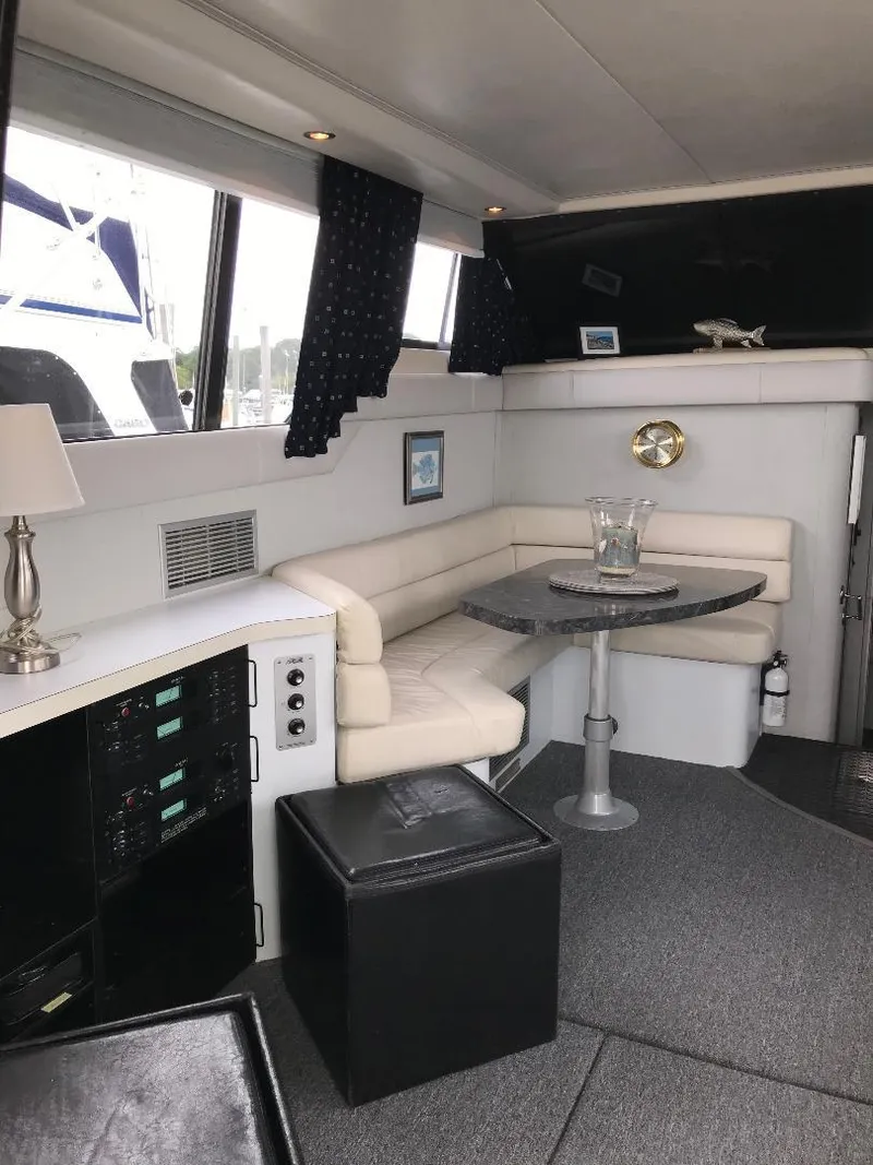 Slide: The Image of 1990 Mainship Mediterranean yacht interior with cozy seating and modern decor. - 23