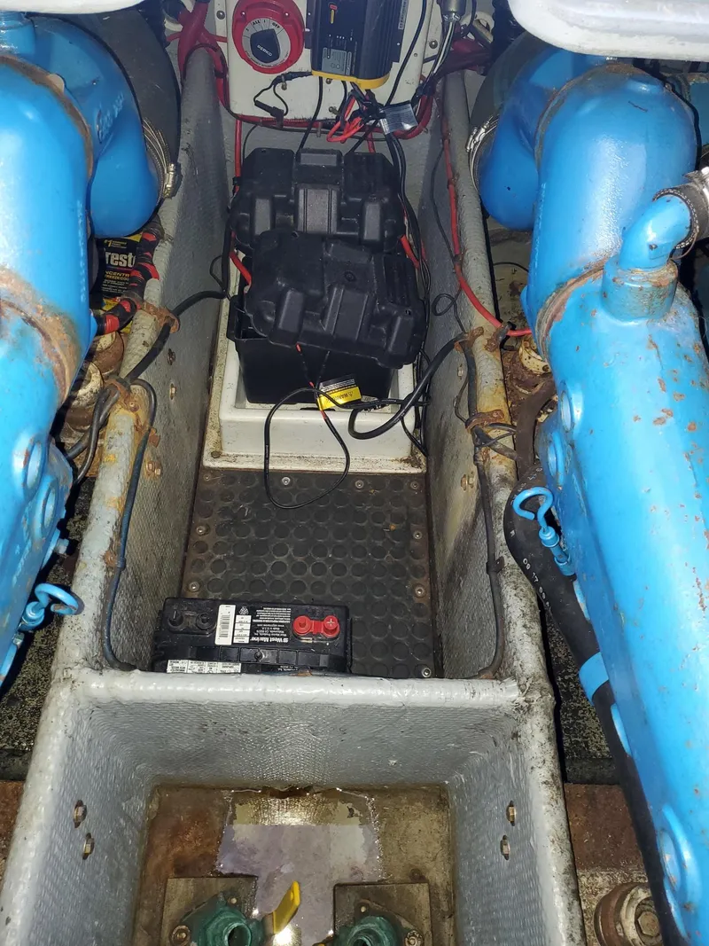 Slide: The Image of Engine room of a 1990 Mainship Mediterranean boat with visible wiring and components. - 33