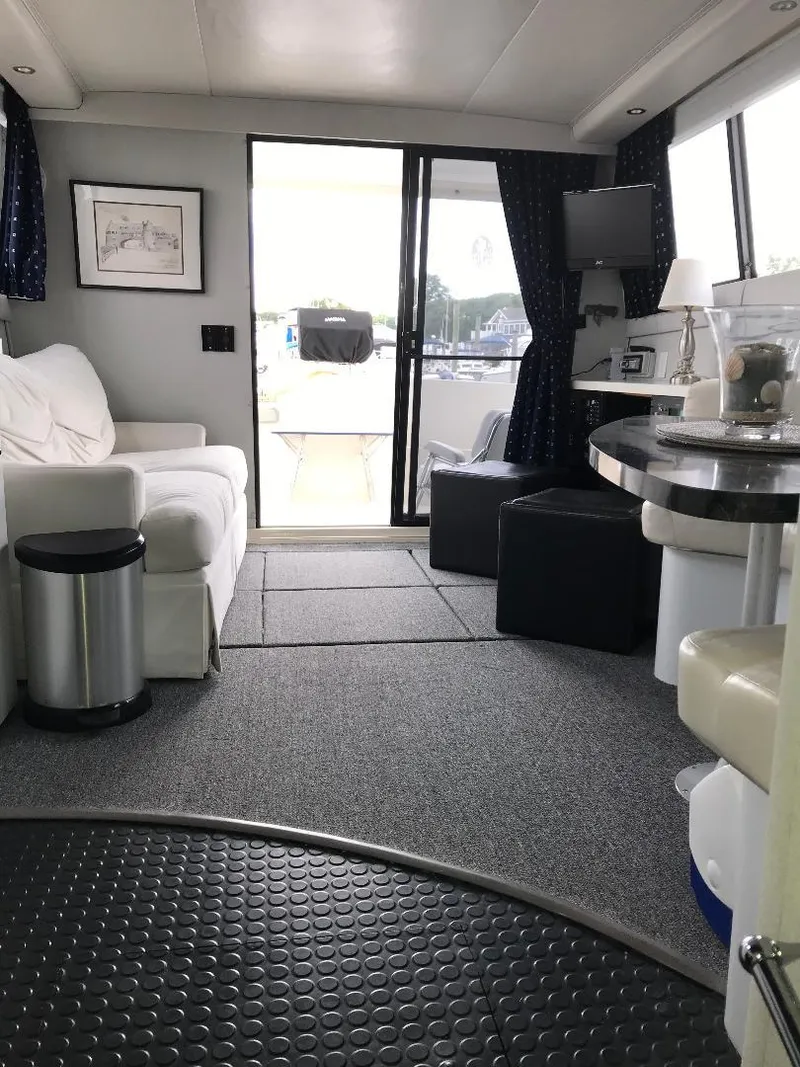 Slide: The Image of Interior of a 1990 Mainship Mediterranean yacht with modern furnishings and large windows. - 34