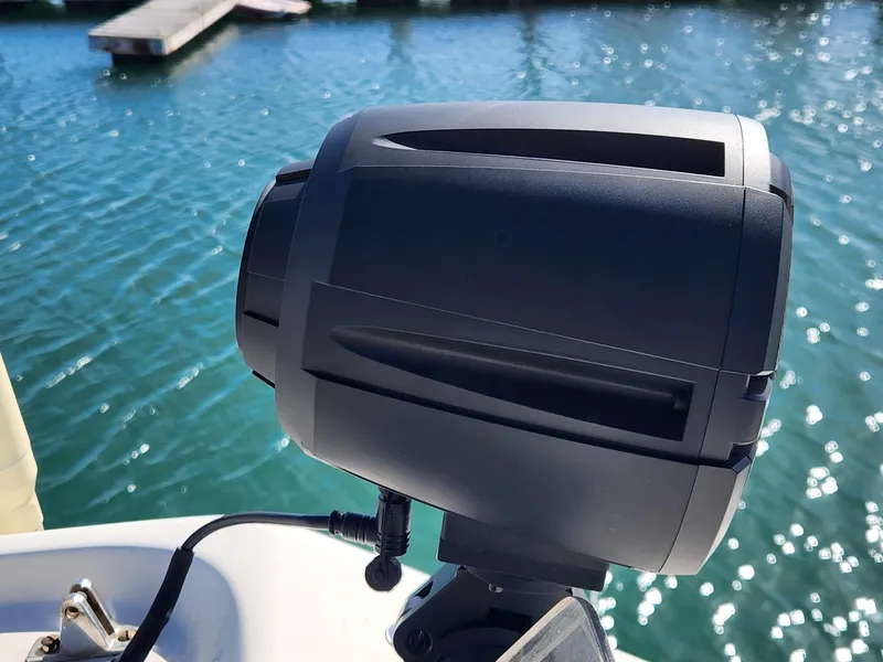 Slide: The Image of Boat spotlight on a 1990 Mainship Mediterranean, docked by shimmering water. - 4