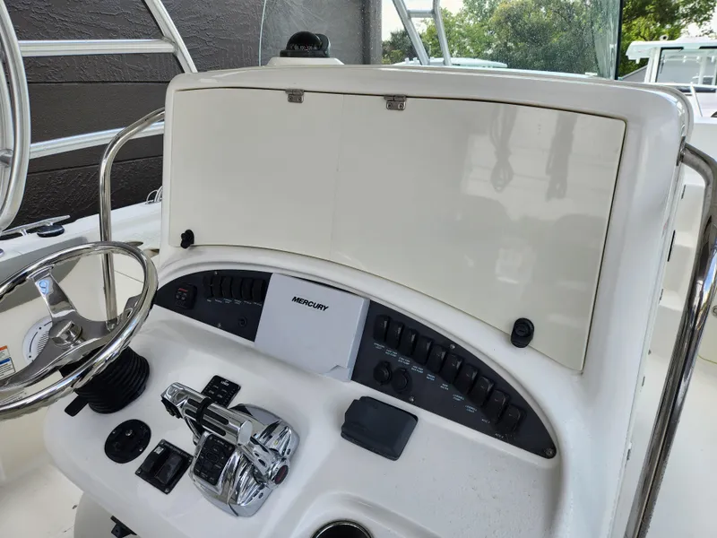 Slide: The Image of 2008 Boston Whaler 320 Outrage Cuddy Cabin helm with steering wheel and controls. - 11
