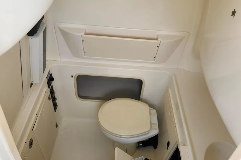 Slide: The Image of 2008 Boston Whaler 320 Outrage Cuddy Cabin interior bathroom with toilet. - 15