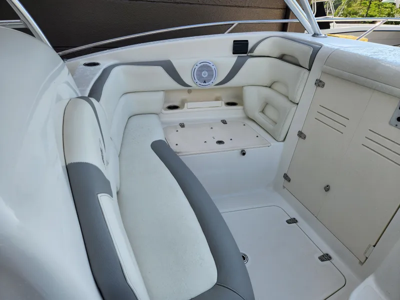 Slide: The Image of 2008 Boston Whaler 320 Outrage Cuddy Cabin interior seating area with storage compartments. - 19