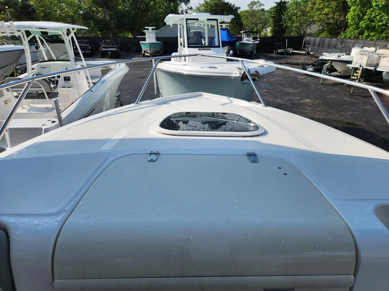 Slide: The Image of 2008 Boston Whaler 320 Outrage Cuddy Cabin in a boatyard, surrounded by other vessels. - 20