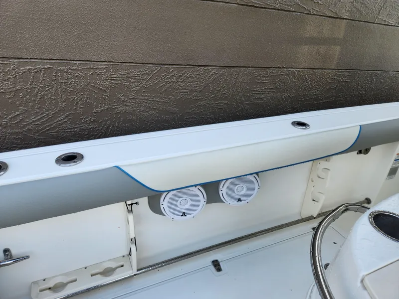 Slide: The Image of 2008 Boston Whaler 320 Outrage Cuddy Cabin interior detail with speakers and rod holders. - 28