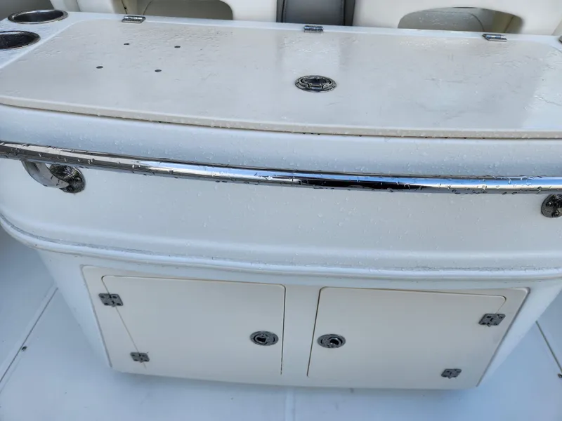 Slide: The Image of 2008 Boston Whaler 320 Outrage Cuddy Cabin storage compartment with chrome accents. - 29