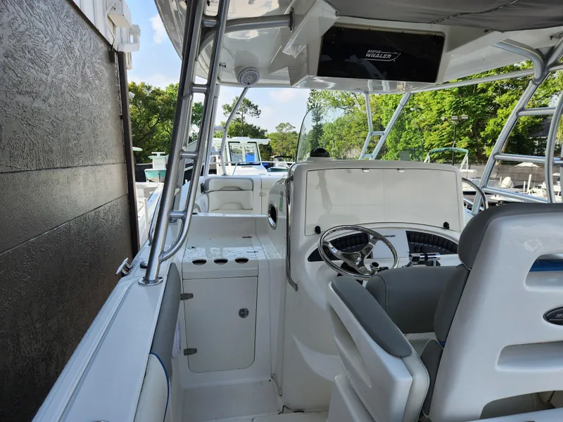 Slide: The Image of 2008 Boston Whaler 320 Outrage Cuddy Cabin interior with steering wheel and seating. - 30