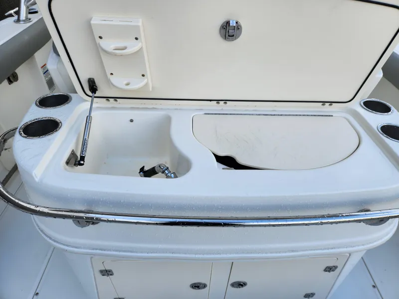 Slide: The Image of 2008 Boston Whaler 320 Outrage Cuddy Cabin boat interior with storage and cup holders. - 33