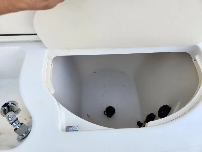 Slide: The Image of Open storage compartment on 2008 Boston Whaler 320 Outrage Cuddy Cabin boat. - 34
