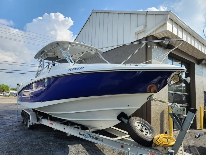 Slide: The Image of 2008 Boston Whaler 320 Outrage Cuddy Cabin on trailer, parked outside building. - 38