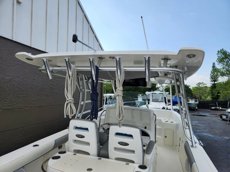 Slide: The Image of 2008 Boston Whaler 320 Outrage Cuddy Cabin boat with T-top and rod holders. - 5