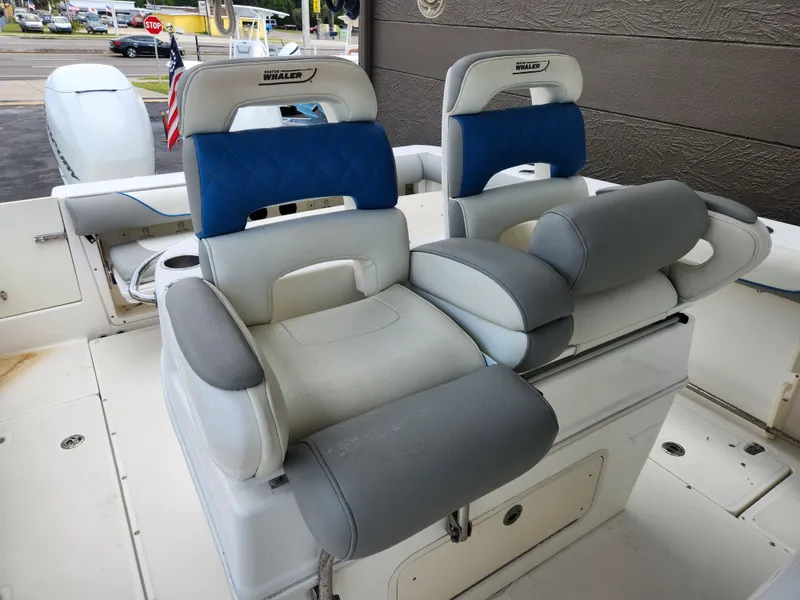 Slide: The Image of 2008 Boston Whaler 320 Outrage Cuddy Cabin boat seats, featuring blue and gray upholstery. - 6