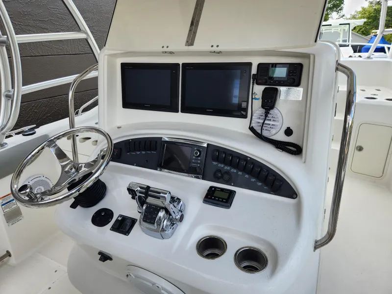 Slide: The Image of 2008 Boston Whaler 320 Outrage Cuddy Cabin helm with dual screens and controls. - 7