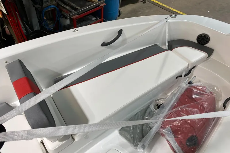 Slide: The Image of 2021 Tahoe T18 boat interior with red and gray seating, secured with straps. - 10