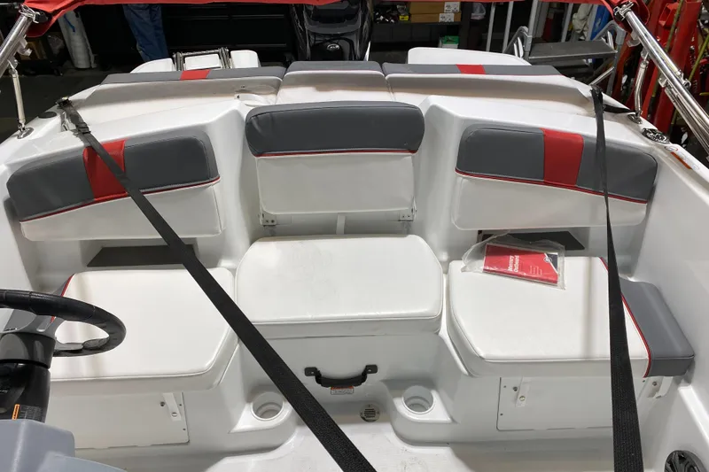 Slide: The Image of 2021 Tahoe T18 boat interior with gray and red seating, featuring storage compartments. - 11