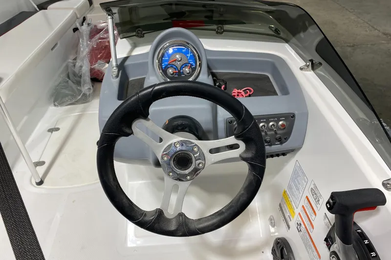 Slide: The Image of Steering console of a 2021 Tahoe T18 boat with gauges and controls. - 12