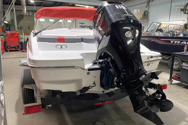 Slide: The Image of 2021 Tahoe T18 boat with outboard motor in a garage setting. - 5
