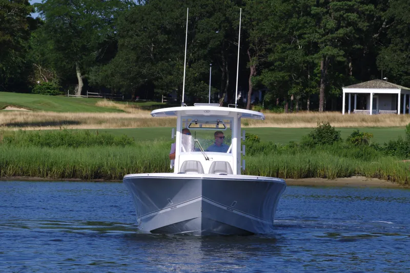 Slide: The Image of 2024 Regulator 30XO boat cruising on a calm lake. - 1