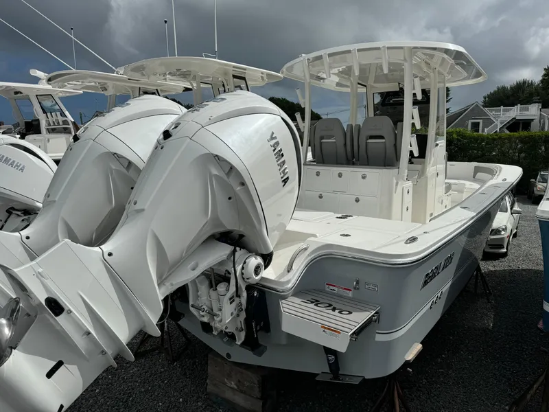 Slide: The Image of 2024 Regulator 30XO boat with twin Yamaha engines in a marina. - 14