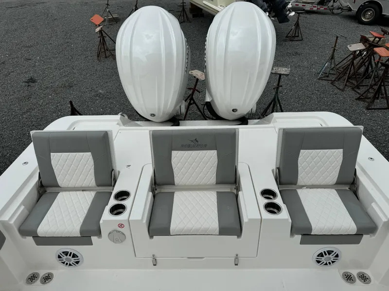 Slide: The Image of 2024 Regulator 30XO boat with dual engines and three cushioned seats. - 16