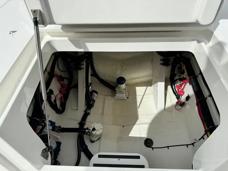 Slide: The Image of 2024 Regulator 30XO boat storage compartment with wiring and equipment. - 17
