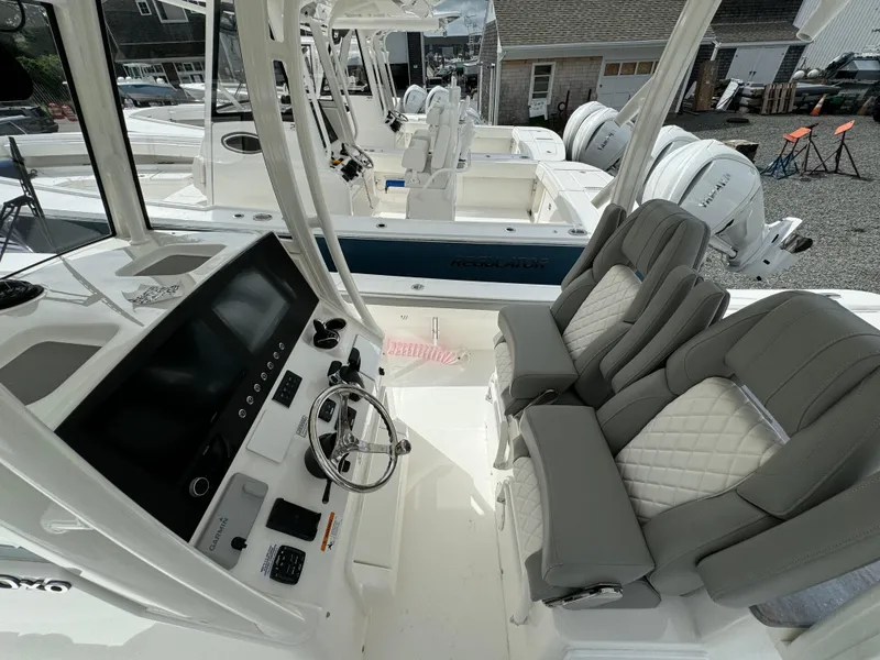 Slide: The Image of 2024 Regulator 30XO boat interior with dual helm seats and modern dashboard. - 18