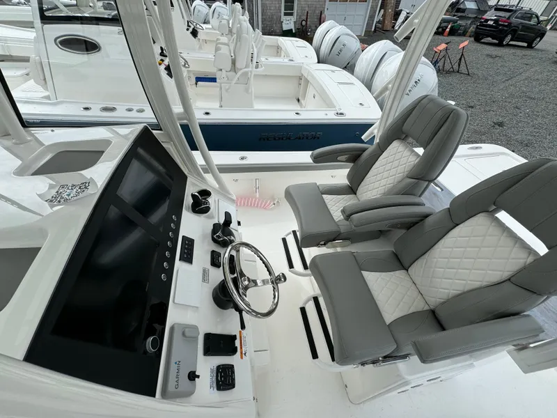 Slide: The Image of 2024 Regulator 30XO boat cockpit with dual captain's chairs and advanced navigation system. - 19