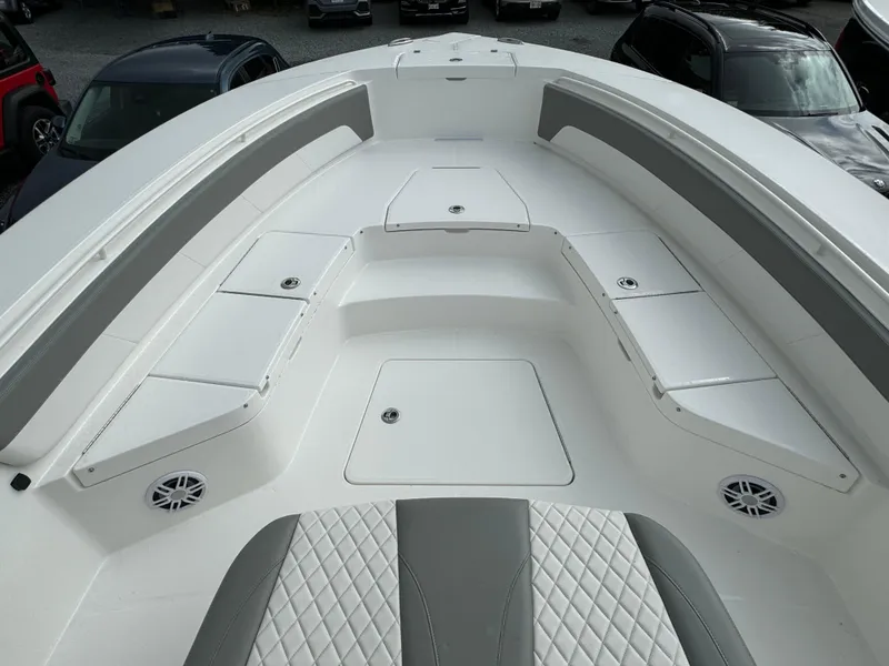 Slide: The Image of 2024 Regulator 30XO boat interior with cushioned seating and storage compartments. - 21