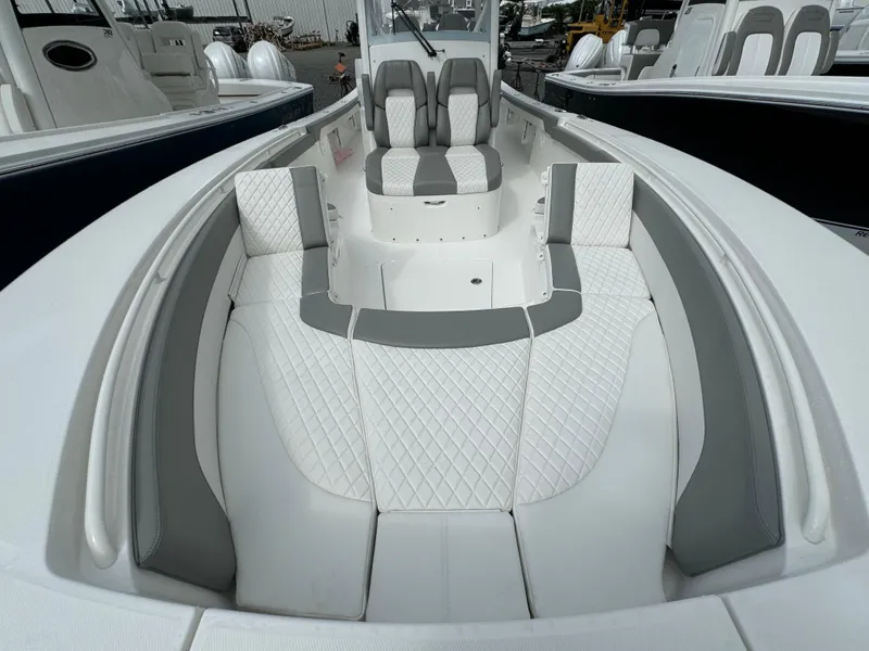 Slide: The Image of 2024 Regulator 30XO boat with white and gray cushioned seating. - 23